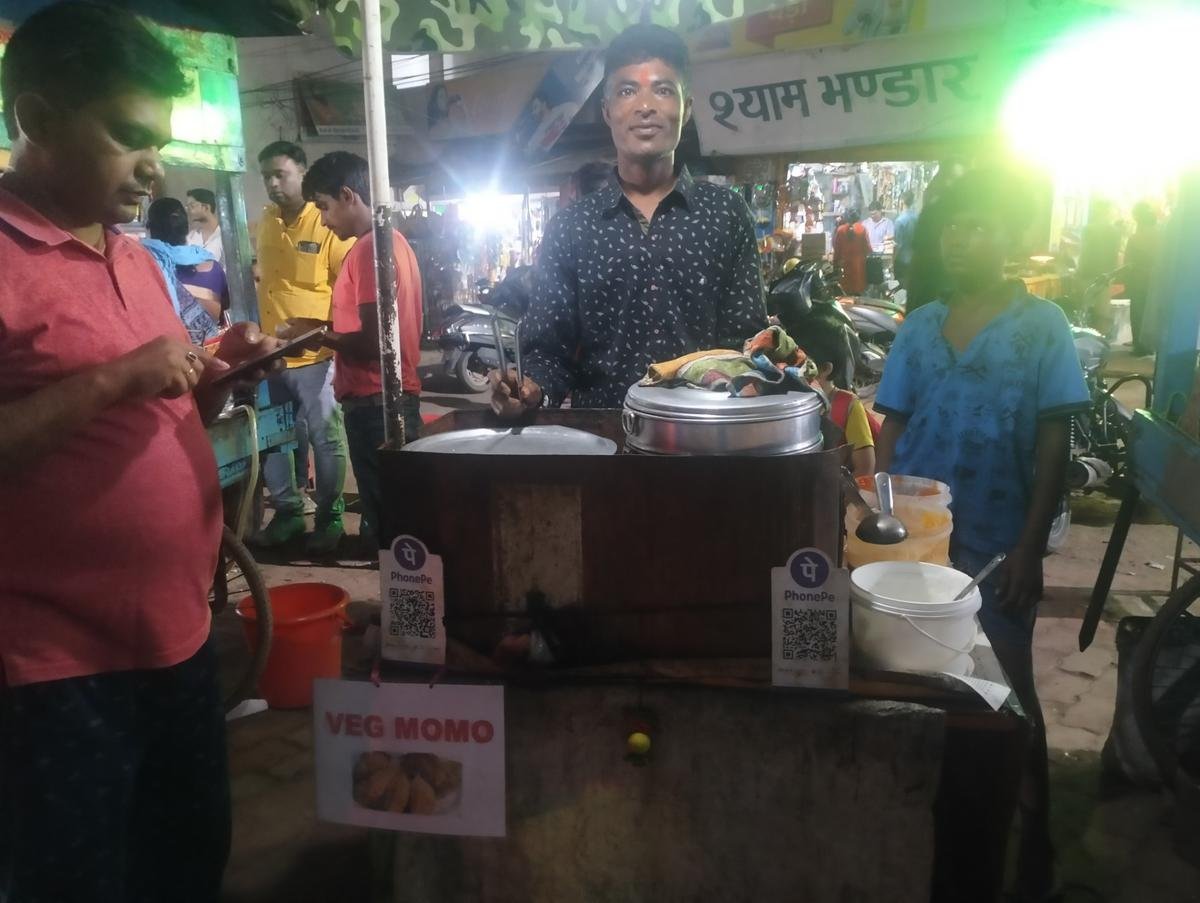 Heavy Engineering Corporation employee Ajay Mirdha sells momos at Argoda Chowk in Ranchi. 