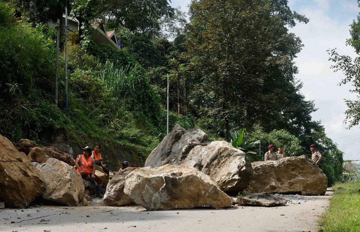 Boulders block a road after flash floods in Naga-Namgor village, Sikkim on October 10, 2023.