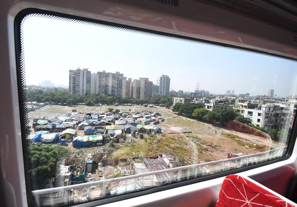 Buildings seen through the window of a RapidX train.